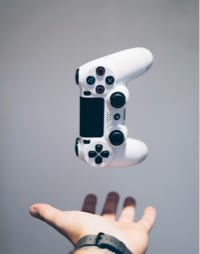 Hand throwing a controller in the air.